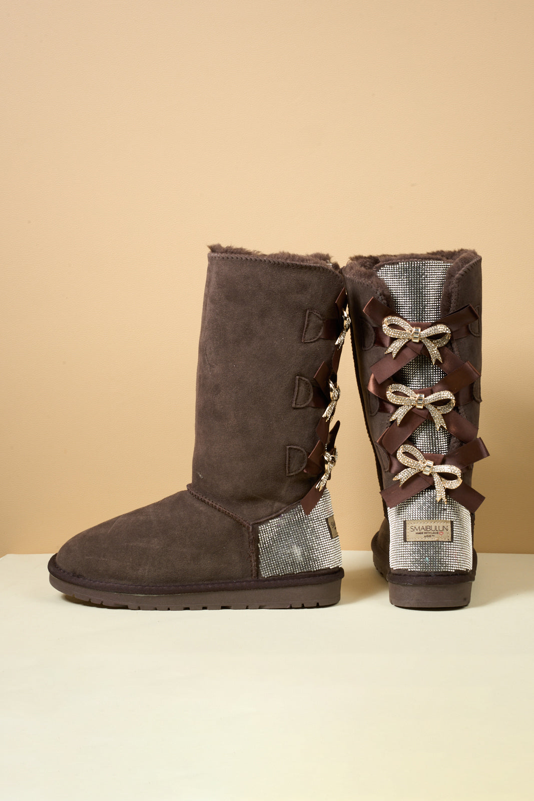 SMAIBULUN Ugg | Rhinestone Ribbon Tri-Tie Bow Suede Boots - brown