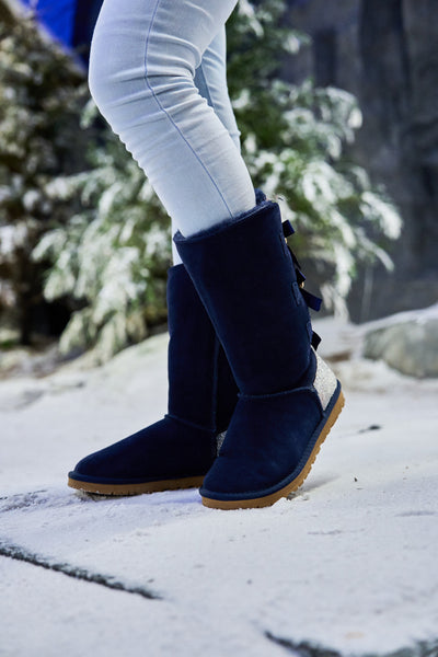 SMAIBULUN Ugg | Rhinestone Ribbon Tri-Tie Bow Suede Boots - Navy