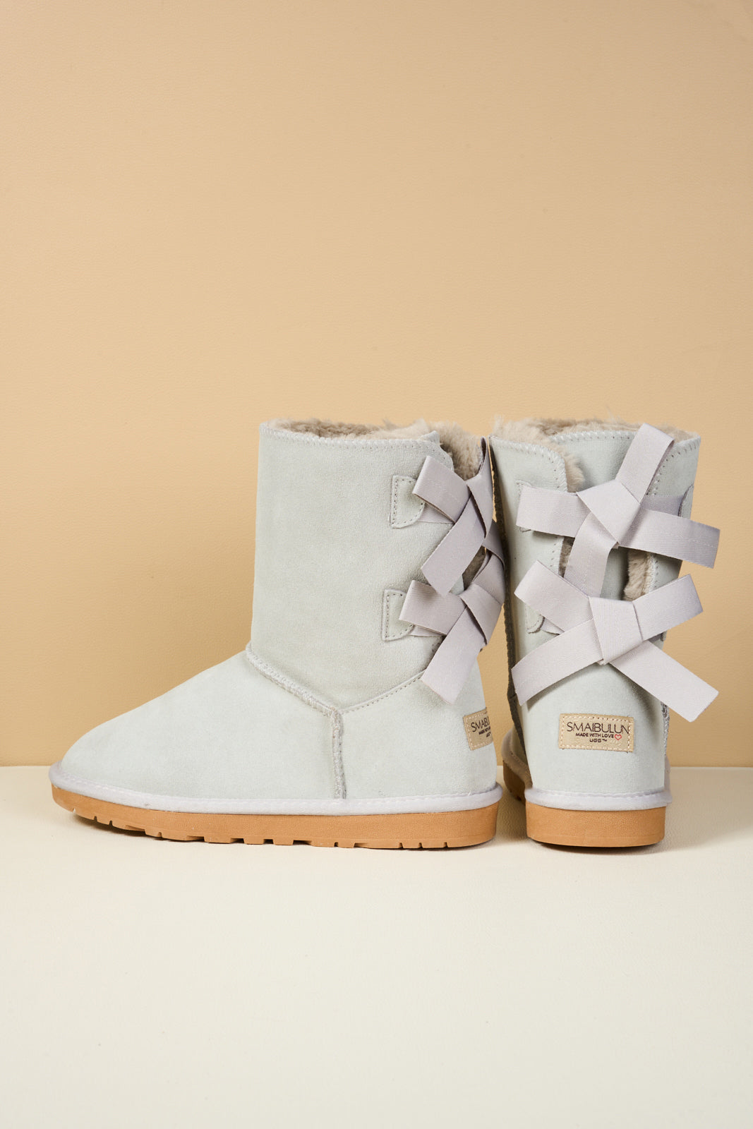 Smaibulun Ugg | Double Ballet Ribbon Bow Suede Shearling Boots - pale