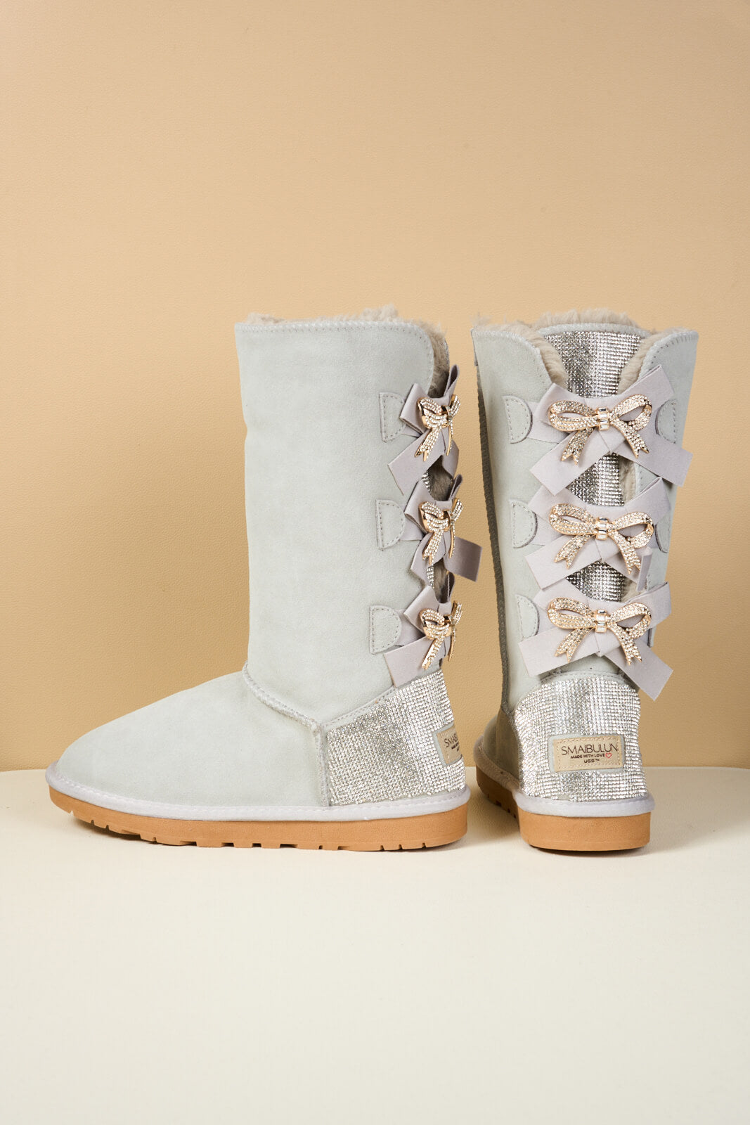SMAIBULUN Ugg | Rhinestone Ribbon Tri-Tie Bow Suede Boots - pale